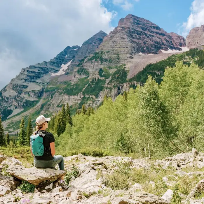 A hiker taking in the mountain landscape at Maroon Bells near Aspen, Colorado