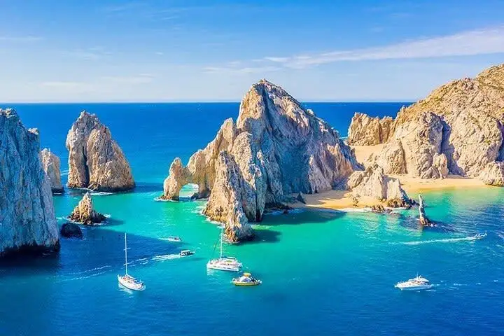 Boats near the dramatic coastal rock formations at Lands End, Los Cabos